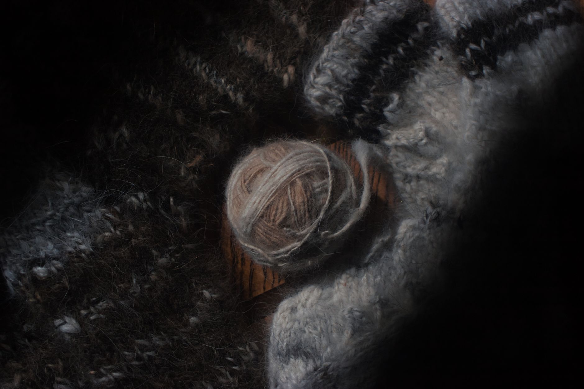 Ball of wool among fabrics